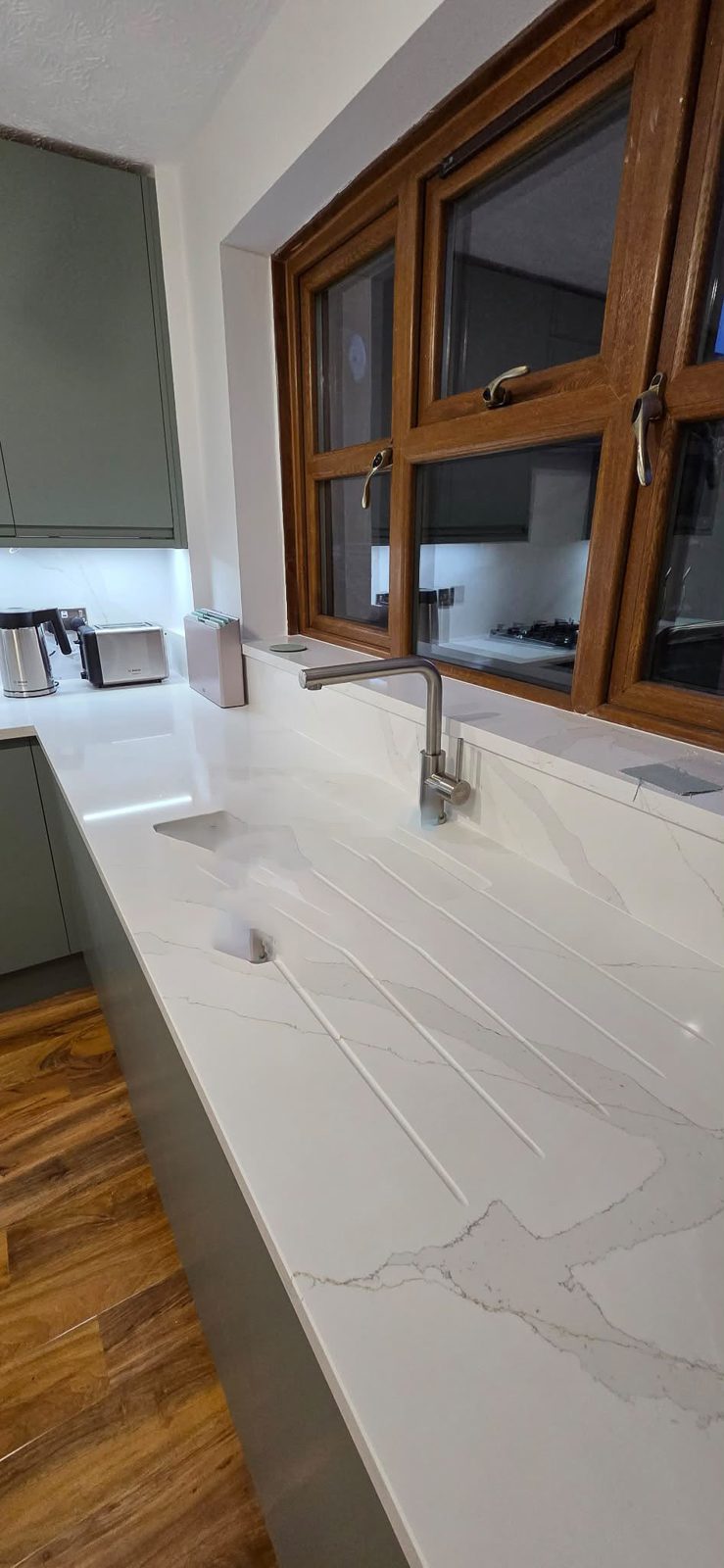 Marble worktop with undermount sink and brushed tap