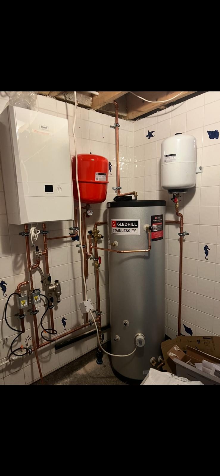Neatly piped hot-water cylinder and plant room